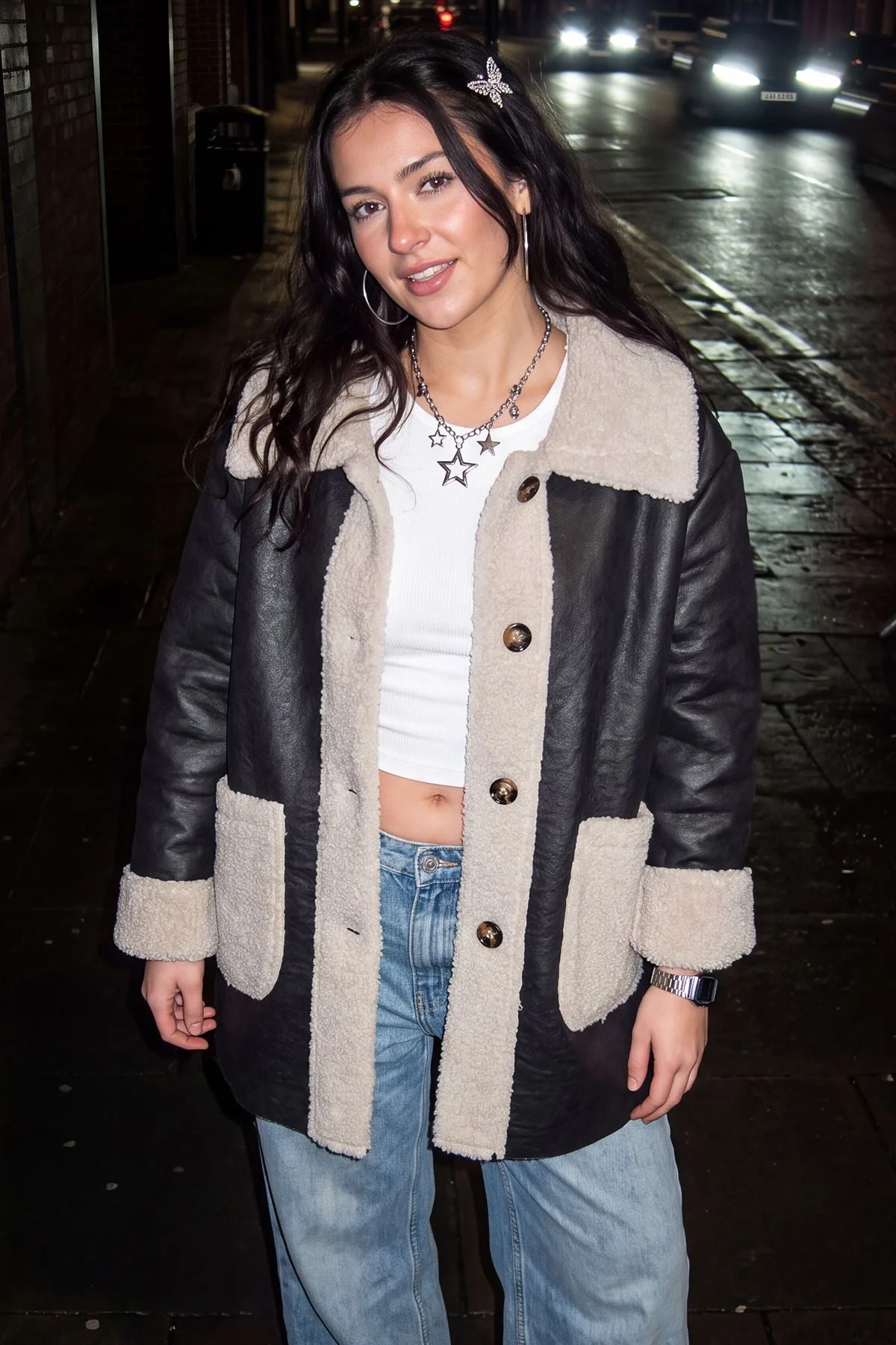 Model in a two-tone faux fur jacket at night