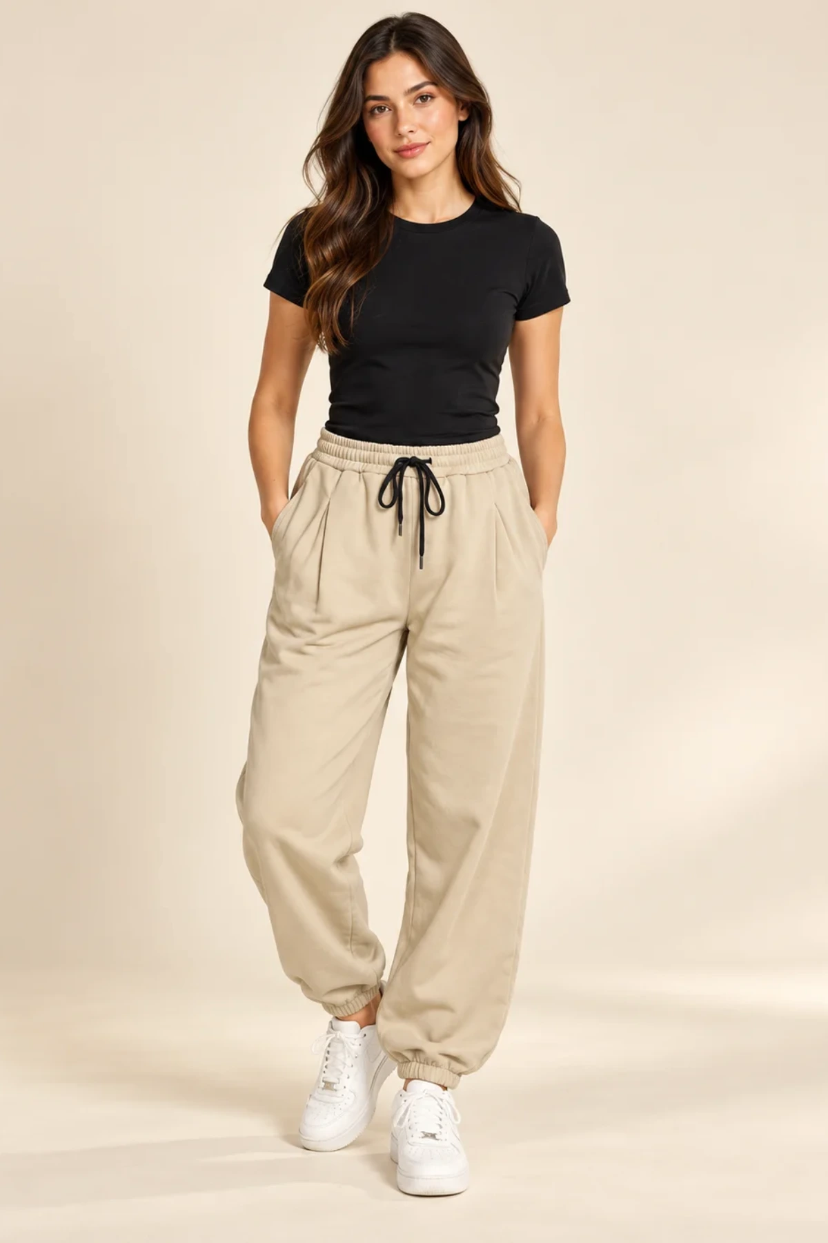 Plain Drawstring Waistband Trousers in beige worn with a black top, photographed in a warm ivory studio
